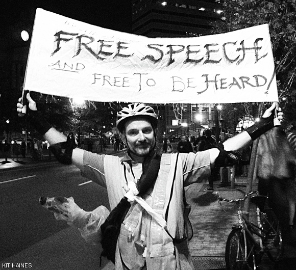 Scooterdude, angry with the lack of media coverage for Occupy Wall Street, tries to spread the message of the protests in New York. He can often be found riding or windsurfing his scooter around Boston.