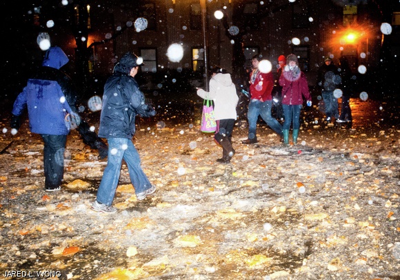 MIT students walk through shattered pumpkins at the bottom of the Green Building. During Pumpkin Drop on Saturday, residents of EC’s First West dropped 120 pumpkins off the roof of the highest point on campus.