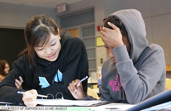 Sara L. Huang ’15 works with achiever Chalayna Smart to analyze an Economist article during the academic portion of Amphibious Achievement’s Sunday mentoring session.