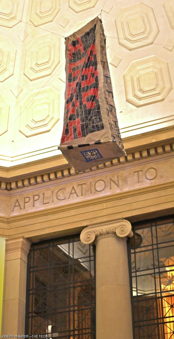 Prior to the start of Bad Ideas Weekend, a painted banner of the Green Building appeared under the dome in Lobby 7. The words “Bad Ideas” are displayed using red and black windows and a QR code taped to the bottom directs viewers to the main website for Bad Ideas, http://bad-ideas.mit.edu.