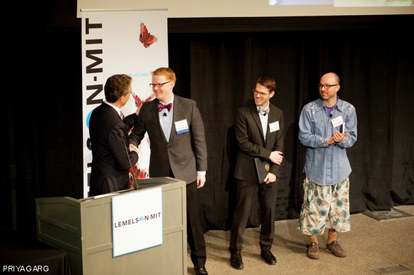 MIT Dean of Engineering Ian A. Waitz presents the $30,000 Lemelson-MIT Collegiate Student Prize to winner Miles C. Barr PhD ’12. Barr invented a novel method of fabricating solar cells on everyday surfaces. Also pictured are finalists Uri Laserson G and Jay S. Silver SM ’08.