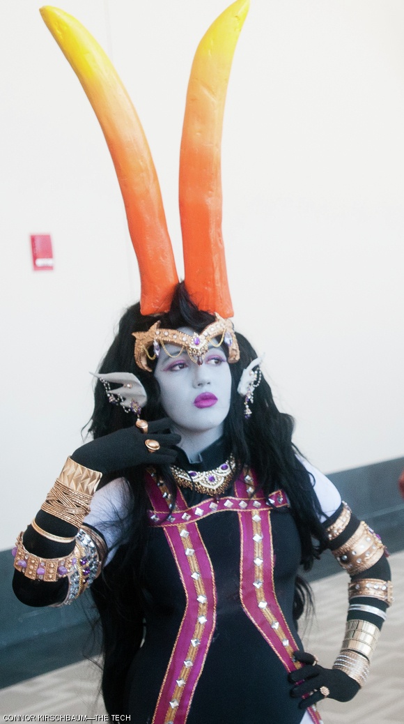 A cosplayer dressed as Betty Crocker aka Her Imperious Condescension from Homestuck poses for the camera.