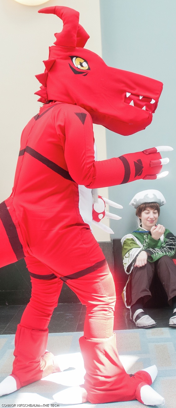 An attendee cosplays as Guilmon, from the TV series Digimon.