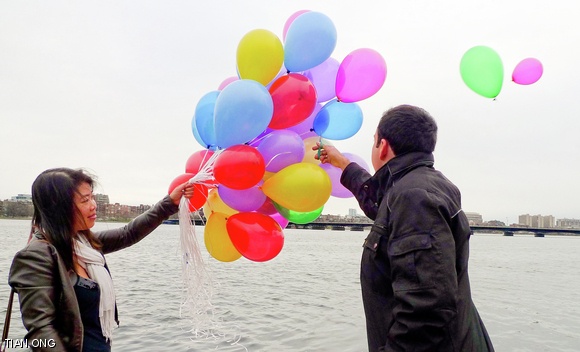 Friends share memories of Phyo N. Kyaw ’10 on April 7 at a memorial service and release balloons over the Charles River to symbolize their loss.