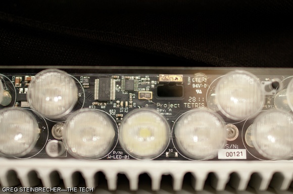 A close up view of board number 121. Of note is the antenna at the top of the image; each pixel is independently controlled via wireless link. The larger black IC is a PIC24FJ32GA — an inexpensive micro controller similar to those found in the popular Arduino boards.