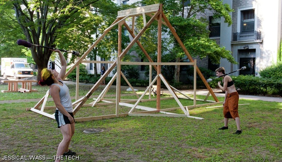 Rebecca J. Greene ’14 and Jessica M. Parker ’15 practice staff spinning on Thursday afternoon in front of one of East Campus’s annual construction projects for REX. This structure will consist of a spinning, oscillating compartment suspended by the triangular frame.