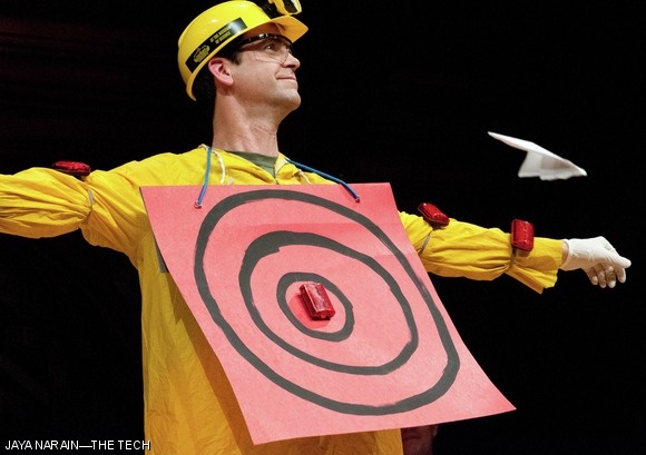 Eric Workman, the “Human Aerodrome,” is the target of paper planes thrown from audience members at the Ig Nobel Prize Ceremony, held Thursday evening in the Sanders Theater at Harvard. Paper plane throwing is a tradition at the ceremony.
