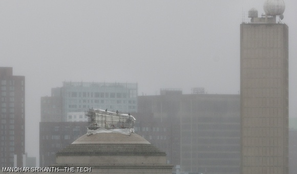 Workers take down portions of the covering over the scaffolding on the Great Dome Monday morning in preparation for Hurricane Sandy’s high winds.