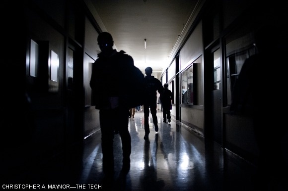 Students make their way down a darkened Infinite Corridor Thursday evening after power went out in Cambridge.