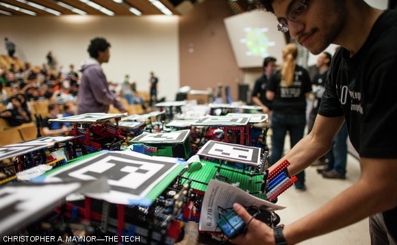 A student picks up his robot during the competition.