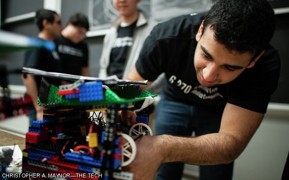 A student fixes a part on his team’s robot.