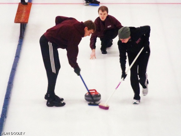 Phillip Nadeau G delivers the rock at the National College Curling Championships.