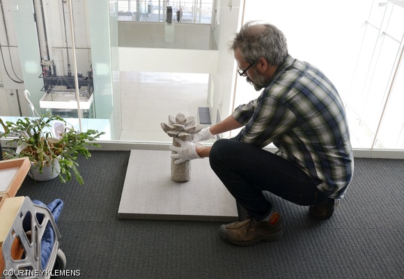 List Visual Arts Center preparatory John Buck installs the sculpture looking over the Media Lab atrium.