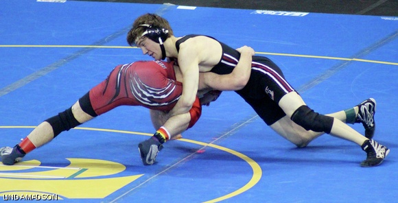Ryan J. Madson ’13 tries to lock up a cradle and score a takedown. Madson won this match with a score of 14-1.