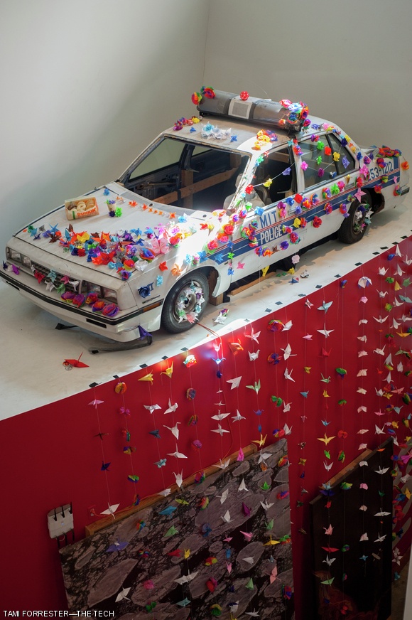 Hundreds of paper cranes and origami flowers were draped on the MIT police cruiser in the Stata Center in honor of Officer Sean Collier.
