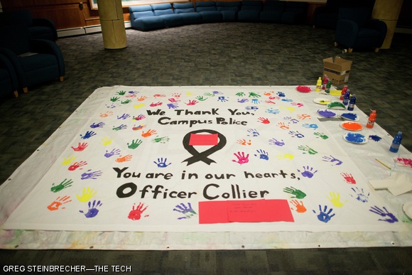 Residents of Next House left hand prints across a poster thanking the MIT Police Saturday night. Residents also wrote individual cards which were then delivered.