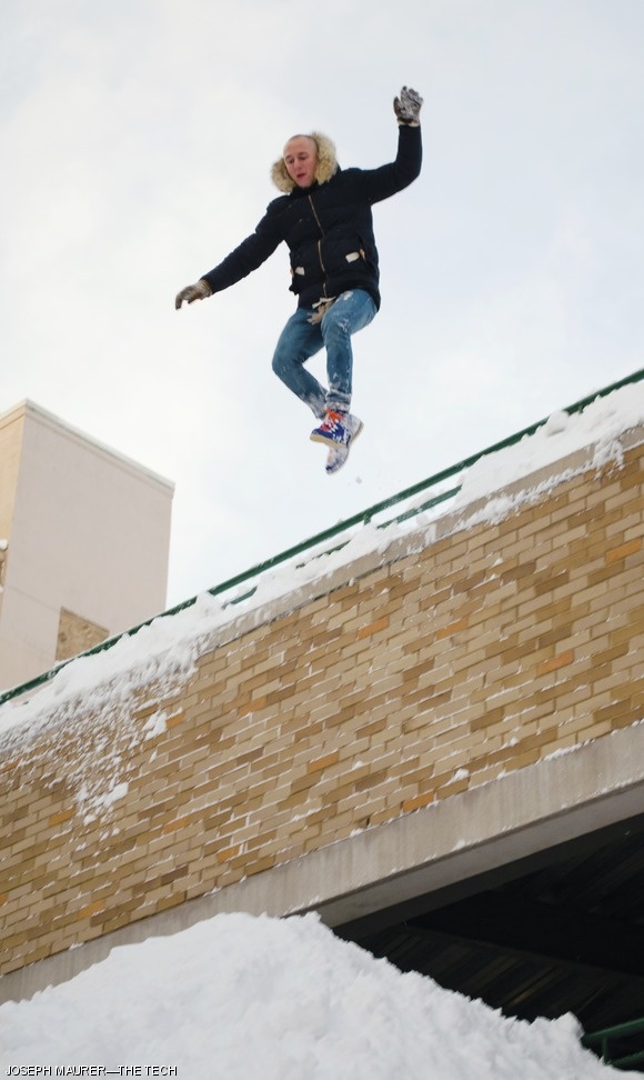 A student jumps into a snow pile from the third floor of Novartis’ parking garage at Cross and Albany Streets on Saturday. The snow pile blocked most of Cross St. across from Edgerton House, and gathered a crowd of a dozen. About half a dozen additional students took the plunge into the loosely packed snow.