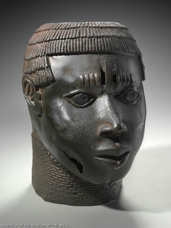The commemorative head of a defeated neighboring leader, from the Edo peoples of the Benin Kingdom, Nigeria. Made of copper alloy and iron, from the late 15th-early 16th century, it is on display in the Benin Kingdom Gallery of the MFA.