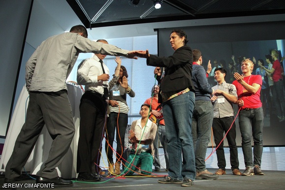 Members from the audience joined MIT Media Lab student, Eric Ross Rosenbaum G, on stage to create a spontaneous rendition of Michael Jackson’s “Billie Jean” by becoming human synthesizers using Makey Makey, a small circuit board that enables anything conductive to control your computer.
