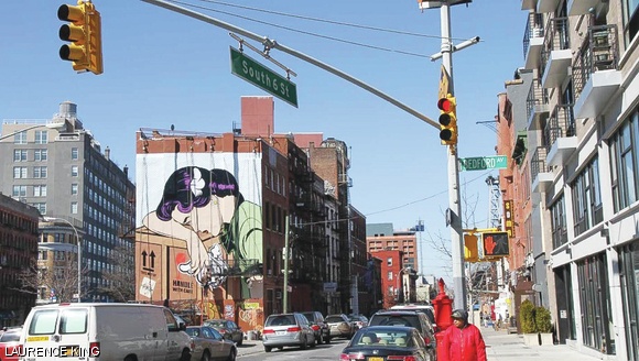 One of D*Face’s works, at Broadway and Bedford Avenue in Brooklyn, shows a woman resting her head on a packing crate that cautions “Handle with care.”