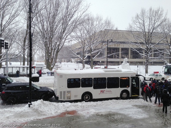 Students weaved their way around an accident involving a Boston Daytime shuttle and a black Porsche Cayenne late Wednesday morning at 77 Mass Ave. The winter storm started early that morning and continued into the afternoon and evening, dropping almost ten inches of snow over Boston and Cambridge.