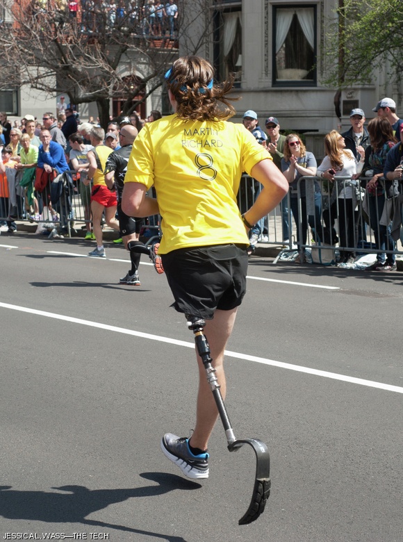 One of one hundred runners selected of the nearly three hundred who applied for Team MR8, the team established by the Martin W. Richard Charitable Foundation, runs the final stretch of Commonwealth Ave. before turning onto Boylston Street and crossing the finish line. The foundation and the team were established by the parents of Martin Richard, the young boy who was killed in the bombings last April.