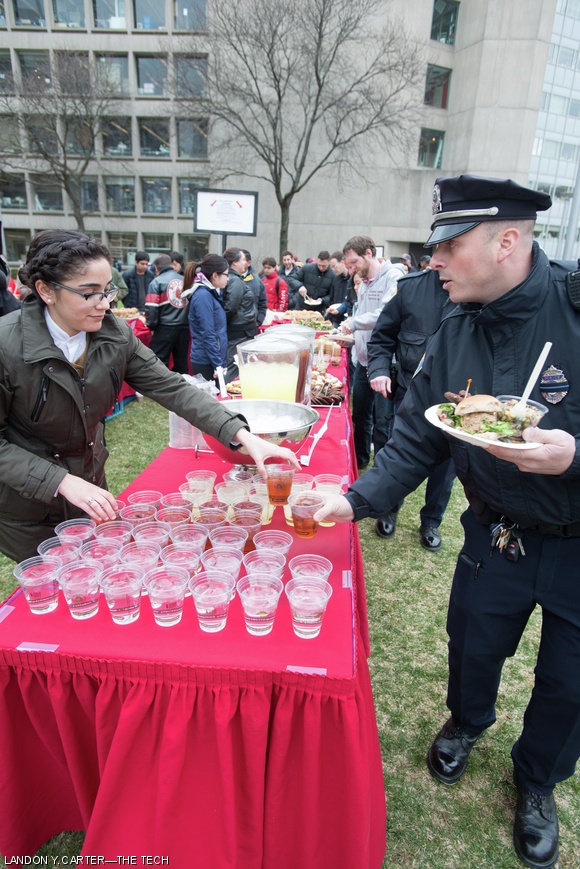 An MIT Police Officer enjoys the food at the community picnic and MIT Strong marathon rally that occurred after the remembrance ceremony last Friday.