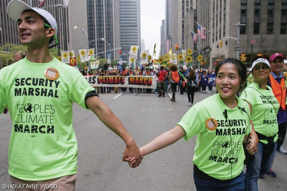 Geoffrey Supran (left), Harvard climate science PhD candidate Ploy Achakulwisut (middle), and other volunteer security marshals clear the way at the front of the People’s Climate March in New York City.