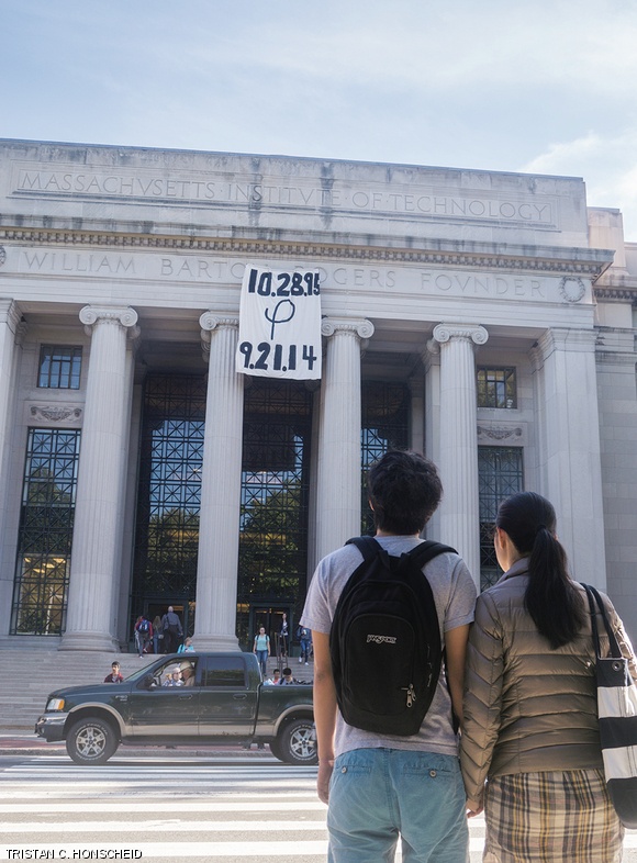 Students view a hack on the facade of building 7 Friday morning in remembrance of Phoebe Wang.
