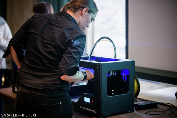 A student uses a MakerBot Replicator 2 to fabricate parts for her project. MakerBot, a company that specializes in desktop 3D printing and scanning, was one of several sponsors of the hackathon.