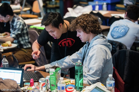 A student discusses his design with a representative from MakerBot.