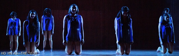 MIT Chamak, a female South Asian fusion dance team, kneels in darkness during a set filled with otherwise upbeat moments.