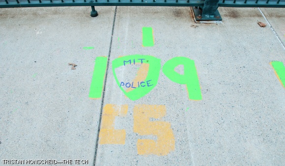 On Tuesday morning, alumni of Lambda Chi Alpha continued their 56-year-old tradition of repainting the Smoot markers on the Harvard Bridge. This year, the 179th Smoot included a tribute to MIT Officer Sean Collier.