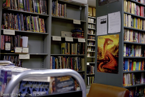 Monday evening found the reopened library in this state. The now-contiguous paperback section extends off to the right, and the taller-spaced shelves of comics, magazines, and references occupy the area to the left. Over 300 books were added to the circulating collection, and around 100 went back into boxes.