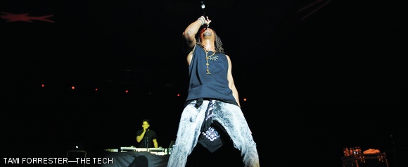 Lupe Fiasco leans back while singing with students at SpringFest 2015.
