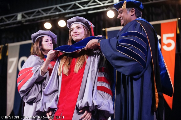 Chancellor Cynthia Barnhart PhD ‘88 and Professor Anantha P. Chandrakasan, the faculty representative for the Department of Electrical Engineering and Computer Science, invest a doctoral degree hood during Thursday afternoon’s hooding ceremony in the Johnson Athletics Center. Michael J. Massimino PhD ‘92, a former NASA astronaut, gave the address to the candidates.